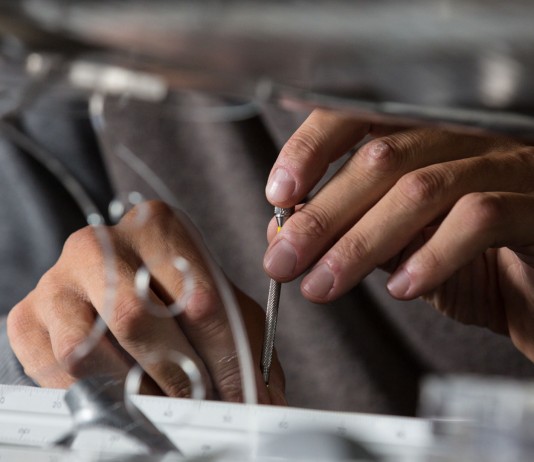 Image of hands building a scale model