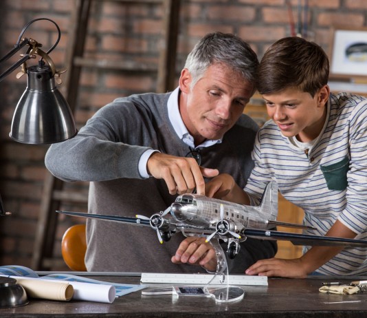 Image of father and son building scale model of DC3