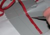 Image of a model maker scribing panel lines on a plastic model plane