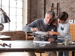 Image of a father and son building a scale model Douglas DC3 airplane, as part of a blog about the top 5 reasons to build scale models with your children.