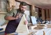 Image of man sanding wood, as the cover image for a blog about abrasives and how to sand scale models.