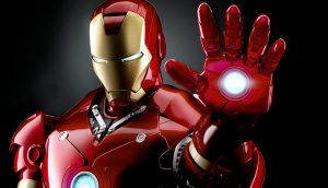 Image of Iron Man in his Mark III armor, with his left hand raised. Dark background.
