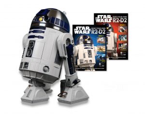Image of an R2-D2 droid buildup together with 2 magazine covers of the model's guides.